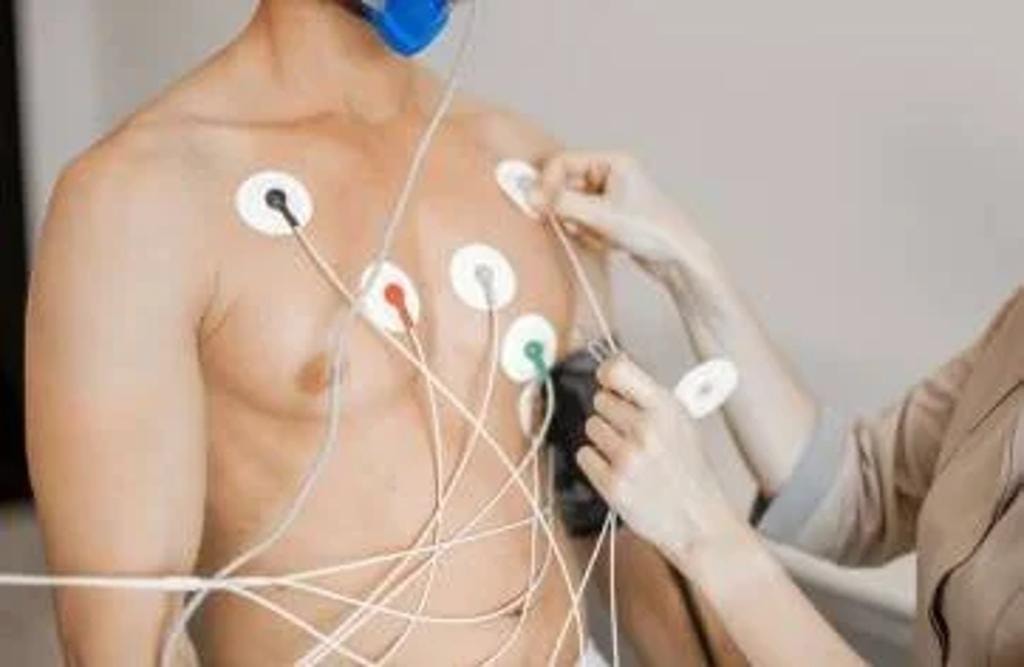Doctor using pocket ECG device with digital readout